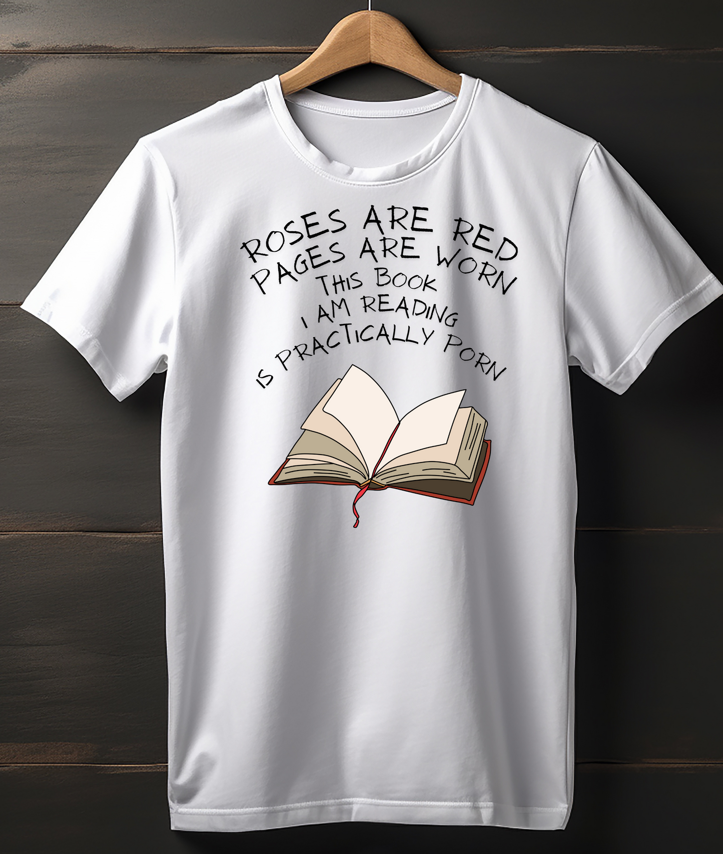 White t-shirt with a book graphic and humorous text on a wooden background