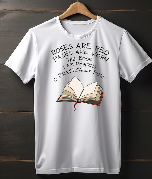 White t-shirt with a book graphic and humorous text on a wooden background